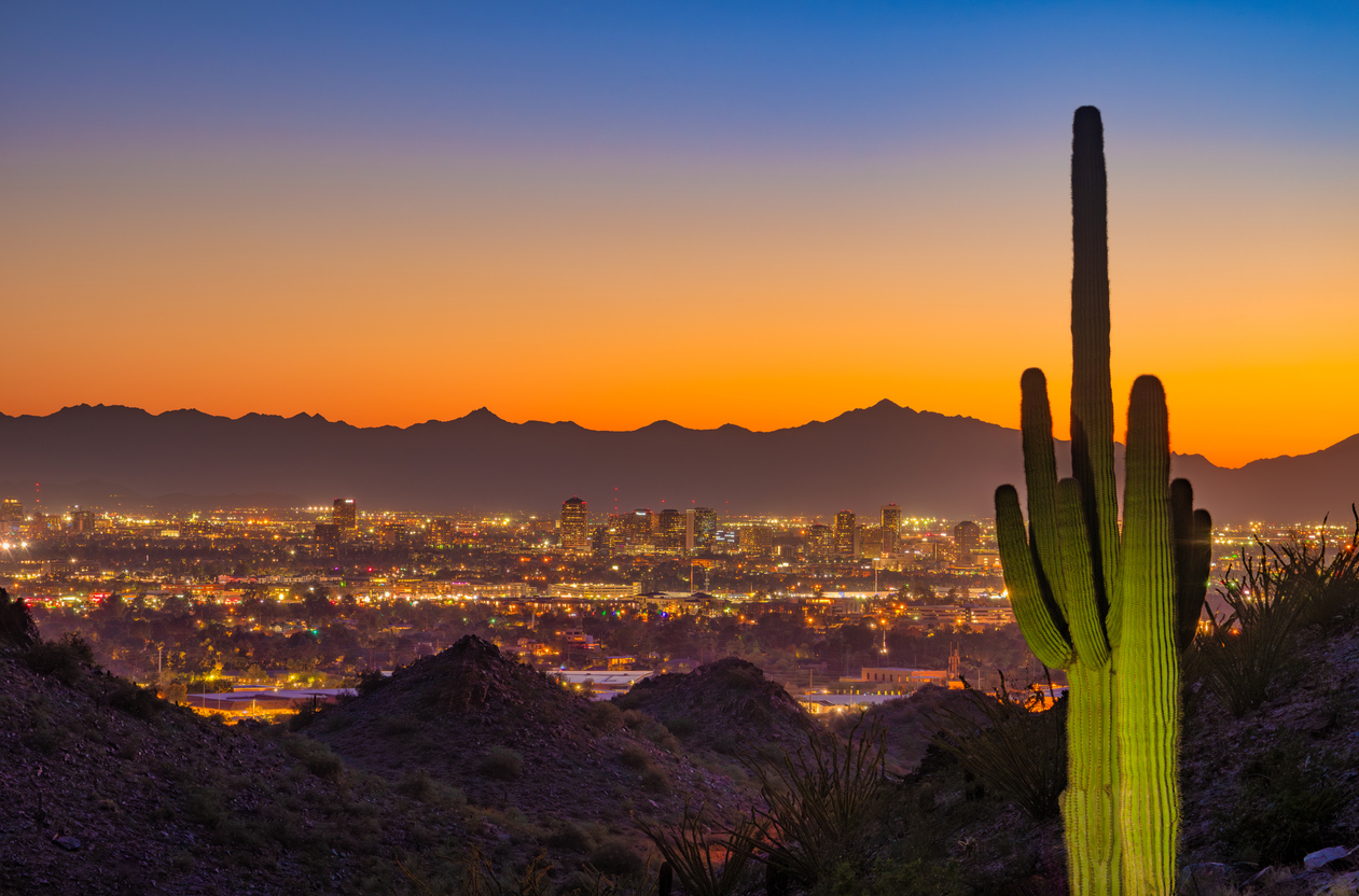 Phoenix skyline at sunset with saguaro cactus in the right foreground